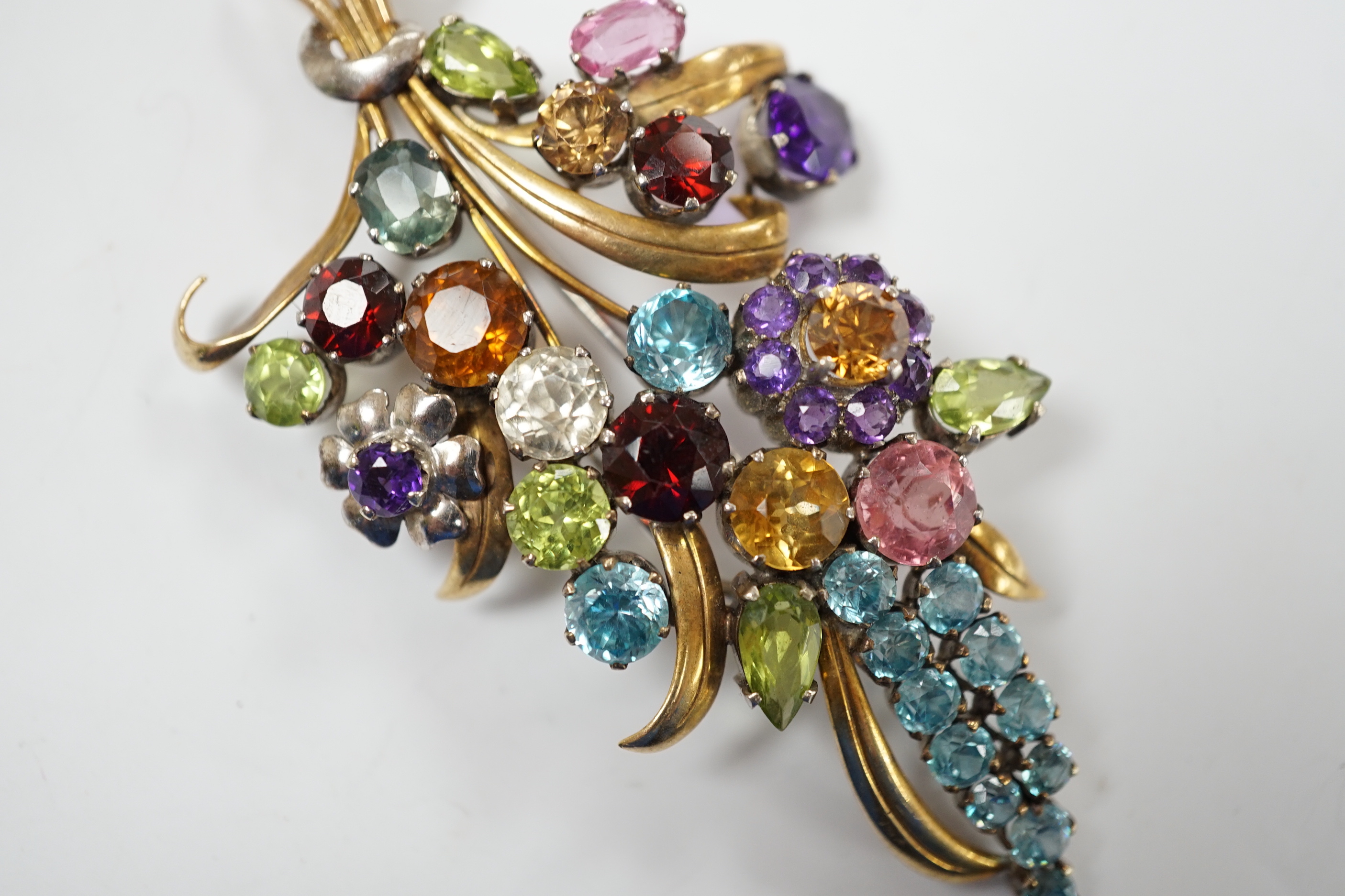 A 9ct and multi gem set floral spray brooch, including zircons, tourmaline and amethyst, by Cropp & Farr, 85mm gross weight 23.1 grams